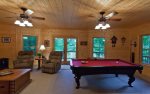 Terrace level pool table and desk area with a flat screen TV